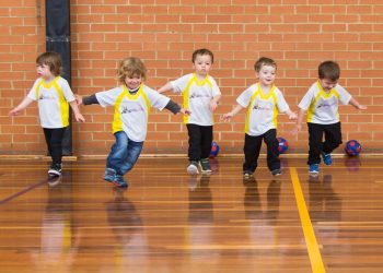 preschool kids playing soccer in class