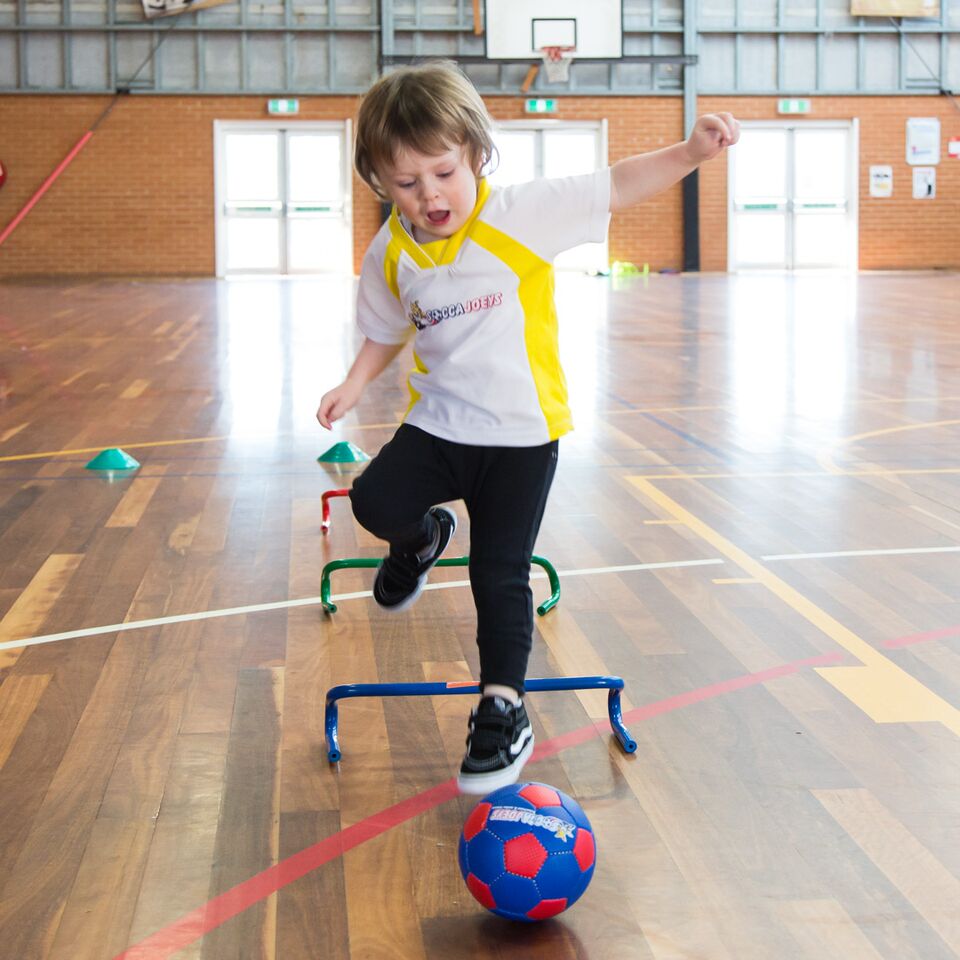 preschool kids playing soccer in class