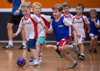 active kids playing soccer action shot